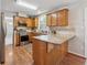 Spacious kitchen with stainless steel appliances, oak cabinets, and granite countertops with breakfast bar extension at 1679 Summit Place Way, Loganville, GA 30052