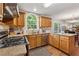 Open-concept kitchen with stainless steel appliances, granite countertops, oak cabinets, and views to the breakfast area at 1679 Summit Place Way, Loganville, GA 30052