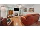 Comfortable living room featuring hardwood floors, fireplace, and leather furniture at 1679 Summit Place Way, Loganville, GA 30052