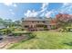 Back exterior with wooden deck, screened in porch and landscaped backyard with mature trees at 3510 Eagle Landing Dr, Snellville, GA 30039
