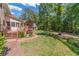 Backyard features include a wooden deck, brick path, fire pit, and lush landscaping at 3510 Eagle Landing Dr, Snellville, GA 30039