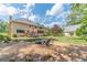 Backyard featuring a cozy fire pit area, mature trees, and well-maintained landscaping at 3510 Eagle Landing Dr, Snellville, GA 30039