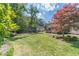 Spacious backyard with a large lawn, mature trees, and well-maintained landscaping at 3510 Eagle Landing Dr, Snellville, GA 30039