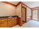 Home wet bar featuring custom wood cabinets, sink and access to outdoor patio at 3510 Eagle Landing Dr, Snellville, GA 30039
