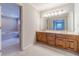 Bathroom boasts double sinks, a large mirror with lighting, and tiled floors surrounding a tub and toilet at 3510 Eagle Landing Dr, Snellville, GA 30039