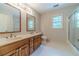 Bathroom featuring double vanity with hardwood cabinetry and a shower with sliding glass doors at 3510 Eagle Landing Dr, Snellville, GA 30039