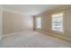 Bedroom with neutral walls, plush carpeting, crown molding, and natural light from two windows at 3510 Eagle Landing Dr, Snellville, GA 30039
