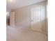 This bedroom features neutral carpet and walls, along with a door and window at 3510 Eagle Landing Dr, Snellville, GA 30039