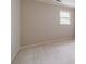This bedroom has neutral-toned walls and carpet and a window with natural light at 3510 Eagle Landing Dr, Snellville, GA 30039