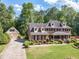 The exterior shows a brick house with a green lawn, mature trees, and a detached garage at 3510 Eagle Landing Dr, Snellville, GA 30039