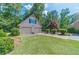 Two-car detached garage with green lawn and mature landscaping at 3510 Eagle Landing Dr, Snellville, GA 30039