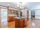 Kitchen features hardwood floors, stainless fridge, wood cabinets and center island cooktop at 3510 Eagle Landing Dr, Snellville, GA 30039