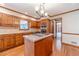 Kitchen with hardwood floors, wood cabinets, stainless appliances and center island cooktop at 3510 Eagle Landing Dr, Snellville, GA 30039