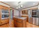 Kitchen features hardwood floors, stainless appliances, double oven and wooden cabinets at 3510 Eagle Landing Dr, Snellville, GA 30039