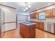 Kitchen features hardwood floors, wood cabinets, stainless appliances and center island at 3510 Eagle Landing Dr, Snellville, GA 30039