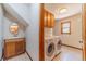 Functional laundry room with washer, dryer, sink, and ample storage cabinets at 3510 Eagle Landing Dr, Snellville, GA 30039