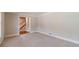 Bright living room with neutral walls, plush carpeting and doorway leading to staircase at 3510 Eagle Landing Dr, Snellville, GA 30039