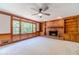 Cozy living room with brick fireplace, built-in bookshelves, and large windows at 3510 Eagle Landing Dr, Snellville, GA 30039
