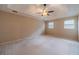Expansive main bedroom featuring tray ceiling, fan, and carpet flooring at 3510 Eagle Landing Dr, Snellville, GA 30039