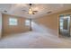 Spacious main bedroom with tray ceiling, windows, carpet flooring and adjoining bath at 3510 Eagle Landing Dr, Snellville, GA 30039
