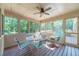 Relaxing screened porch with ceiling fan, table, and chairs, perfect for outdoor enjoyment at 3510 Eagle Landing Dr, Snellville, GA 30039
