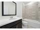 Bathroom featuring shower and tub combination, toilet, large mirror, and dark-stained vanity at 784 Keystone Dr, Woodstock, GA 30188