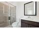 Bathroom featuring glass shower, toilet, large mirror, and dark-stained vanity with modern fixtures at 784 Keystone Dr, Woodstock, GA 30188