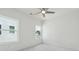 Bright bedroom featuring neutral carpet, two windows, ceiling fan, and light-colored walls at 784 Keystone Dr, Woodstock, GA 30188