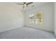 Bedroom with ceiling fan, windows with neighborhood views, and neutral carpet at 784 Keystone Dr, Woodstock, GA 30188