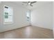 Bright bedroom with ceiling fan, two large windows with neighborhood views, and white trim at 784 Keystone Dr, Woodstock, GA 30188