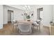Bright dining room featuring a modern chandelier, round table with seating for four, and light wood floors at 784 Keystone Dr, Woodstock, GA 30188