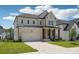 A two-story home featuring a brick front, covered porch and a two-car garage at 784 Keystone Dr, Woodstock, GA 30188