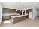 Modern kitchen features a large island, stainless steel appliances, and stylish pendant lighting at 784 Keystone Dr, Woodstock, GA 30188