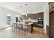 Bright kitchen with island, stainless steel appliances, sleek cabinets, and hardwood floors at 784 Keystone Dr, Woodstock, GA 30188