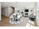 Open-concept living room with hardwood floors, fireplace, and plenty of natural light at 784 Keystone Dr, Woodstock, GA 30188
