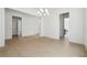 Open-concept living room featuring bright hardwood floors and a modern chandelier at 784 Keystone Dr, Woodstock, GA 30188