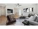 Open living space with hardwood floors, ceiling fan, and comfortable seating area at 784 Keystone Dr, Woodstock, GA 30188