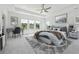 Spacious main bedroom with carpet, ceiling fan, and large windows offering serene views at 784 Keystone Dr, Woodstock, GA 30188