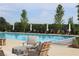 Upscale community pool with clear blue water, surrounded by lounge chairs and umbrellas, perfect for relaxation at 784 Keystone Dr, Woodstock, GA 30188