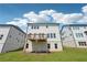 A two-story home featuring a small elevated wood deck overlooking a well-manicured lawn at 784 Keystone Dr, Woodstock, GA 30188