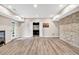 Finished basement with durable floors, stone-look accent wall, and stylish white doors at 1231 Ellington Ct, Cumming, GA 30041