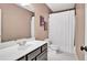 Bathroom featuring a shower with white curtain, and a sink with a grey vanity at 1231 Ellington Ct, Cumming, GA 30041