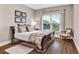 Bedroom with neutral colored walls, matching furniture, and a natural light window at 1231 Ellington Ct, Cumming, GA 30041