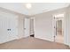 This bedroom features neutral walls, carpet flooring, double closet and a decorative ceiling light at 1231 Ellington Ct, Cumming, GA 30041