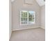 Bright bedroom with plush carpeting, a window with scenic outdoor views, and neutral walls at 1231 Ellington Ct, Cumming, GA 30041