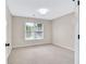 Bright bedroom with a window, neutral walls, plush carpeting and modern light fixture at 1231 Ellington Ct, Cumming, GA 30041