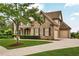 Charming brick home featuring a well-manicured lawn and a two-car garage at 1231 Ellington Ct, Cumming, GA 30041