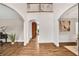 Grand foyer with beautiful hardwood floors, open arches, and second-story balcony at 1231 Ellington Ct, Cumming, GA 30041