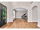 Bright and airy foyer featuring hardwood floors and arched doorways leading to other rooms at 1231 Ellington Ct, Cumming, GA 30041