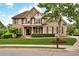 Elegant brick home with lush lawn, manicured landscaping, and welcoming front porch at 1231 Ellington Ct, Cumming, GA 30041